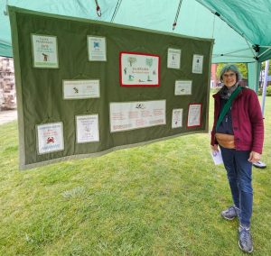 Rosemary in front of State of Nature tapestry